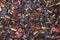 black tea with lemongrass, currant berries, sea buckthorn berries, rose petals, cornflower petals background top view