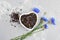Black tea mix with dried cornflower petals and thyme in ceramic bowl. Herbal tea