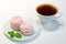 Black tea with pink blueberry marshmallow. Sweets decorated with