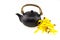 Black tea pot with Mokkara yellow Orchid flower isolated on whit