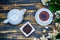 Black tea in a white cup and saucer and jasmine flowers