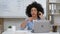 Black Teacher Guy Wearing Headset Talking To Camera Sitting Indoors