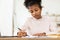 Black Teen Girl Writing Doing Homework Learning Sitting At Home