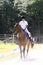 Black teenage girl riding horse