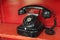 Black telephone set in red phone box