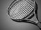 Black tennis racket rendered on dark