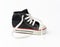Black textile children`s sneaker with white untied shoelaces on a white background