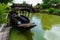 Black Thai wooden boat stay green canal