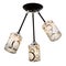 Black three-lamp ceiling lamp with white cylindrical shades ornamented with golden rings of different sizes