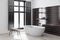 Black tile bathroom corner, white tub