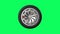 Black tire with alloy wheel spinning on green screen