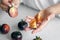 Black tomatoes in female hands close-up, cooking in the kitchen.