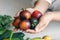 Black tomatoes in female hands close-up, cooking in the kitchen.