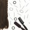 Black tools for the hairdresser and hair on white background. Beauty composition. Flat lay, top view