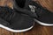Black torn sneakers dirty on wood background, Footwear for outdoor activities. Torn shoes. Shoe repair