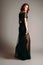 Black transparent long evening dress. Beautiful slim bending model, modern feminine look for a party.