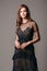 Black transparent long evening dress. Beautiful slim bending model, modern feminine look for a party.