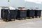 Black trash containers on street, environmental pollution