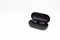 Black true wireless earbuds with power bank case on white isolated background
