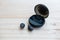 Black true wireless earbuds with power bank case on the wooden background