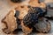 Black truffles of Saint John on a beige burlap.Thinly sliced mushrooms. Raw champignons. Top view. Shallow depth of