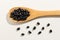 Black Turtle Bean legume. Healthy grains on a wooden spoon. Whit