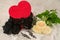 Black underwear knickers in gliter red box heart shaped perfume white roses juwelery  on white background