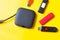 Black USB HUB with usb stick flash drives on yellow background. Top view