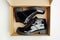 Black varnished patent leather shoes in cardboard box