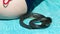 Black venomous snake curled up in ball on a blue towel