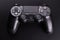 Black video game controller, joystick for game console  on black background
