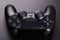 Black video game controller, joystick for game console isolated on black background
