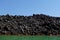 Black Volcanic Rock Shore With Seabirds