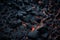 Black volcanic stones, fiery lava. Texture abstract background. Generative AI