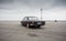 black Volga sedan parked on big empty asphalt field