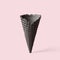 Black wafer ice cream cone on a pink background. Minimalistic concept