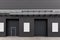 Black wall of the building with doors, emergency exits