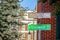 Black Wall Street and N Greenwood Avenue street signs - closeup - in Tulsa Oklahoma with bokeh background
