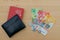 Black wallet with Swiss passport and swiss currency