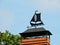 Black weather vane on home roof, Lithuania