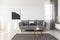 Black and white abstract painting on empty wall of cozy living room interior