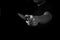 Black and White Adult Man Holding Sharp Knife in the Shadow. Concept Picture of Murderer, Killer, Assasin, Robber or Theft