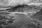 Black and white Aerial view of flying drone Epic dramatic Autumn landscape image of Llyn Idwal in Devil`s Kitchen in Snowdonia