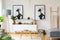 Black and white african posters above cabinet in living room int