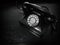 Black and white antique dial telephone on table