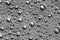 Black-and-white background with big and small grey bubbles inside a gray liquid.