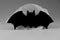 A black and white bat on grey background. Usually decoration on halloween party