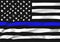 A black, white and blue waving stars and stripes USA American flag in memorial of Police Officers that have died in the line of