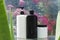 Black and white bottles of shampoo, hair conditioner on the glass wet shelf.Natural and organic hair treatments