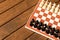 Black and white chess on a chessboard on a wooden table. Chess g